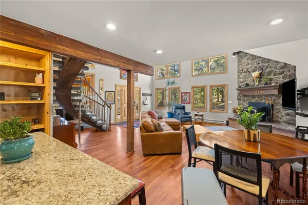 a living room with furniture a rug and a large window