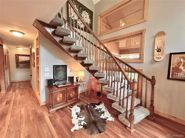 a view of entryway and hall with wooden floor