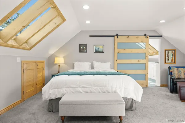 a bedroom with a bed and a couch