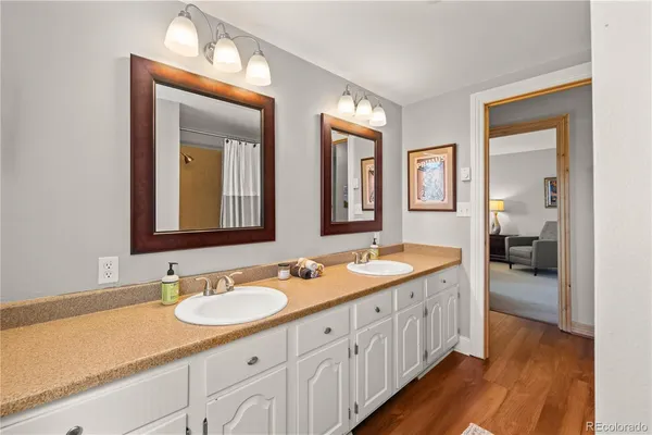 a spacious bathroom with double sink and a mirror