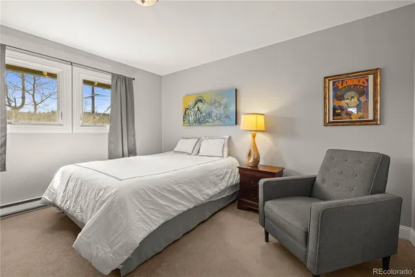 a bedroom with a bed and a couch