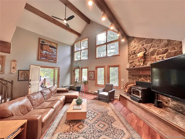 a living room with furniture a rug and a flat screen tv