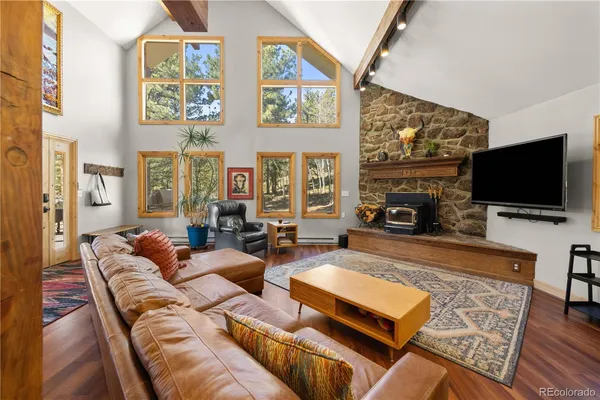 a living room with fireplace furniture and a flat screen tv