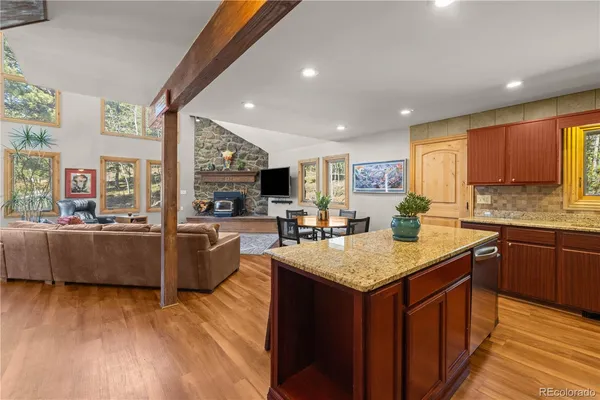 a kitchen with a sink stove and wooden cabinets