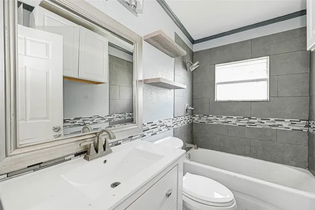 a bathroom with a sink a toilet and bathtub