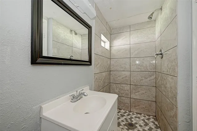 a bathroom with a sink a mirror and vanity