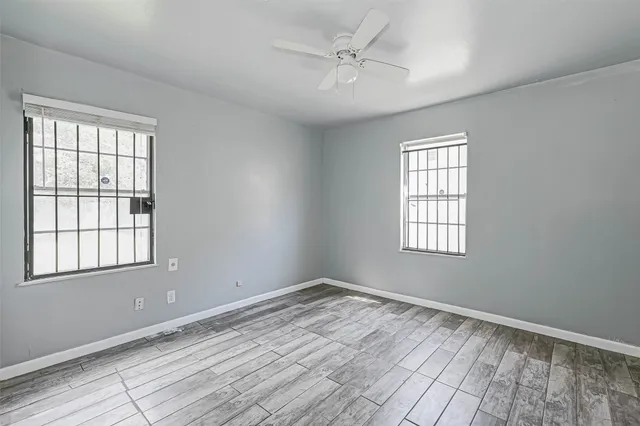 wooden floor in an empty room with a window