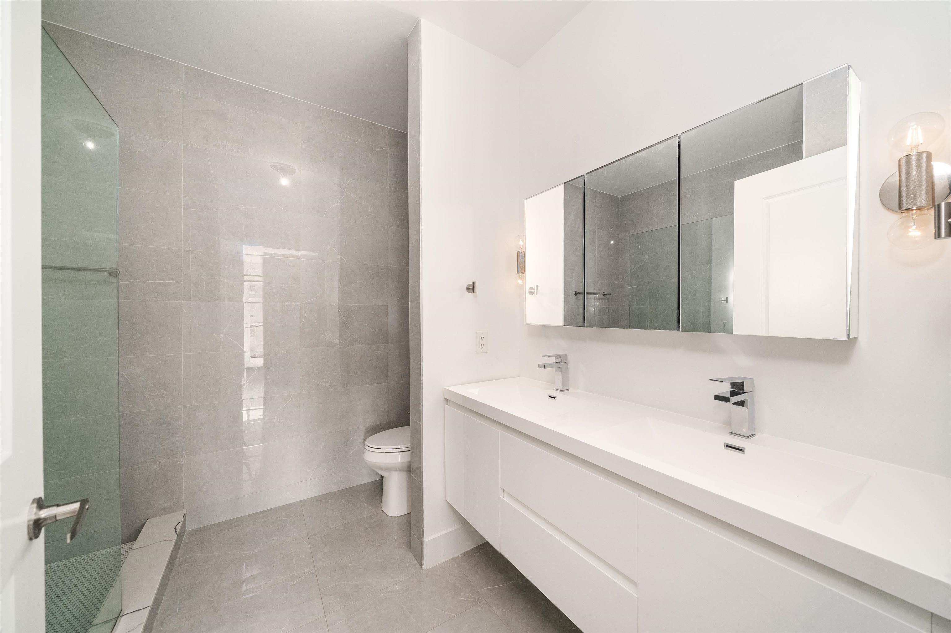 8621 River Road, Unit 4A North Bergen, NJ 07047 - Photo 17 of 42 a bathroom with a double vanity sink toilet and shower