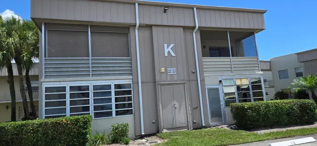 a front view of a house with plants