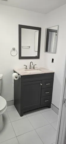 a bathroom with a sink vanity and mirror