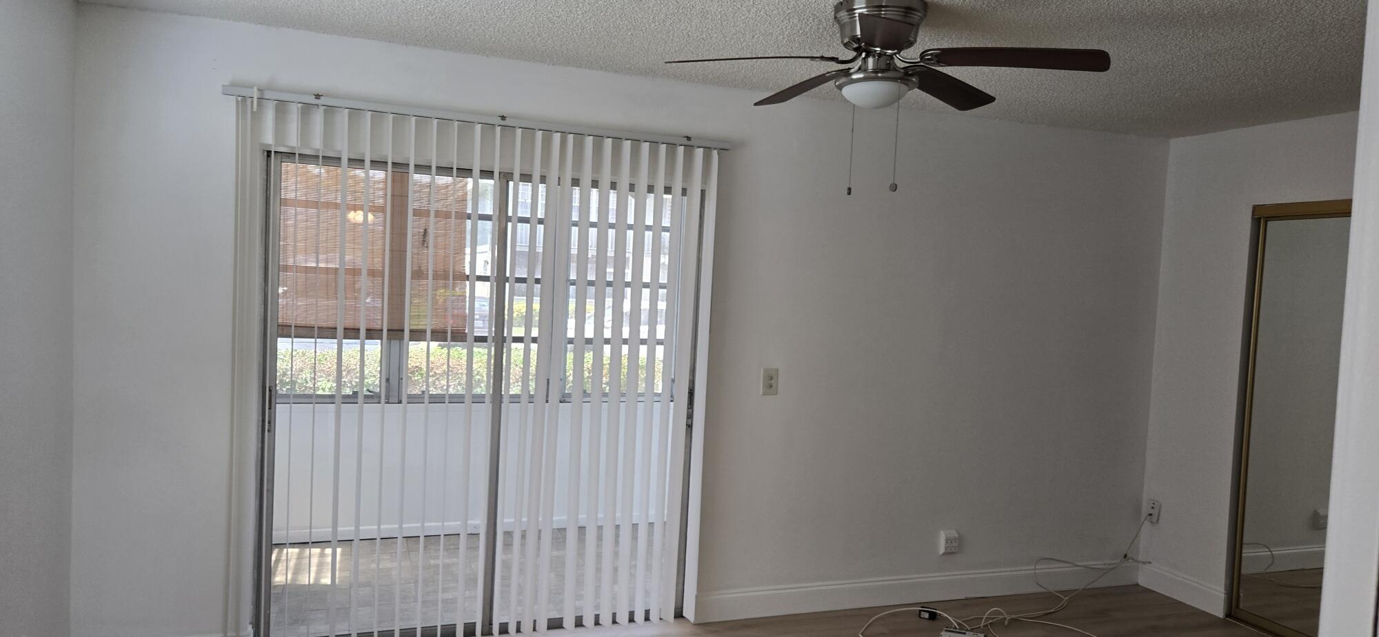497 Flanders K Delray Beach, FL 33484 - Photo 9 of 15 a view of an empty room with a window