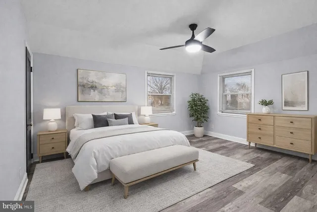 a spacious bedroom with a large bed and a dresser