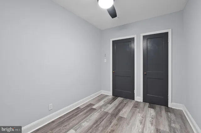 an empty room with closet and a window