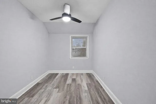 a view of room with a ceiling fan and window