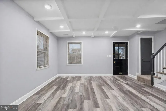 a view of a big room with windows and a bedroom