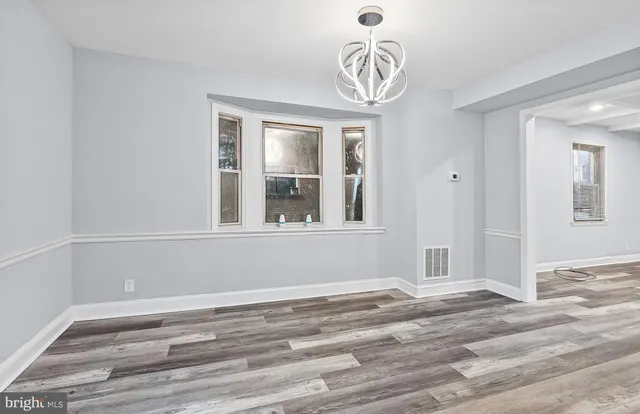 a view of a room with wooden floor and windows