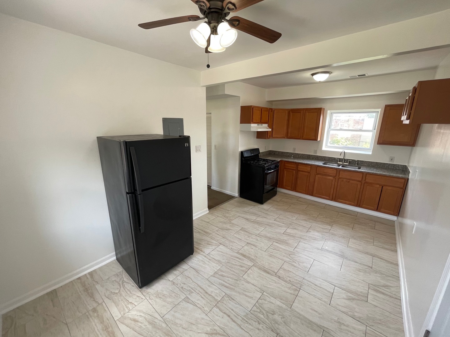 649 East Marquette Road, Unit 3 Chicago, IL 60637 - Photo 6 of 15 a kitchen with granite countertop a refrigerator and a sink