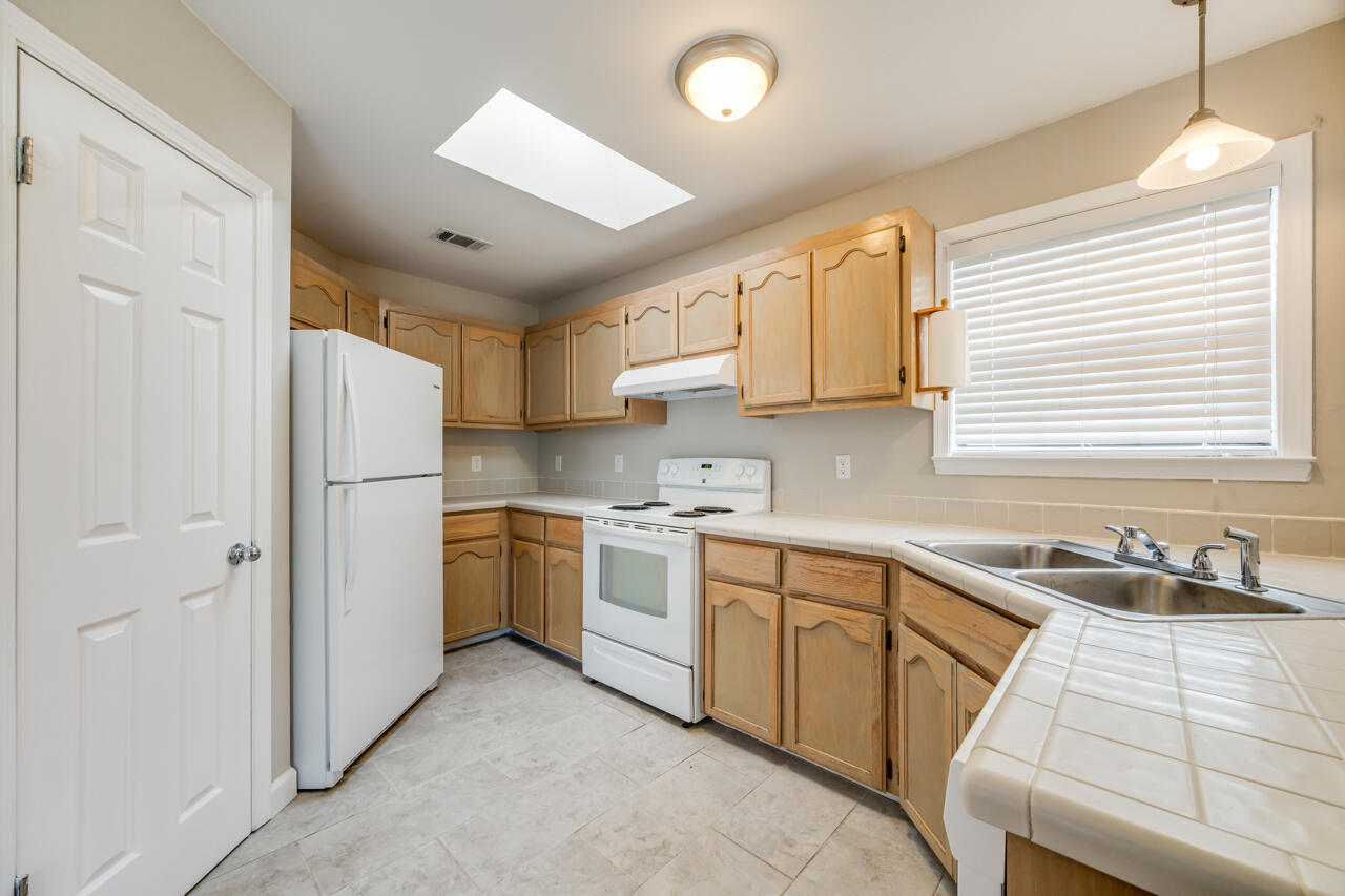 519 Krest Drive Crestview, FL 32536 - Photo 11 of 37 a kitchen with a sink cabinets stainless steel appliances and a window