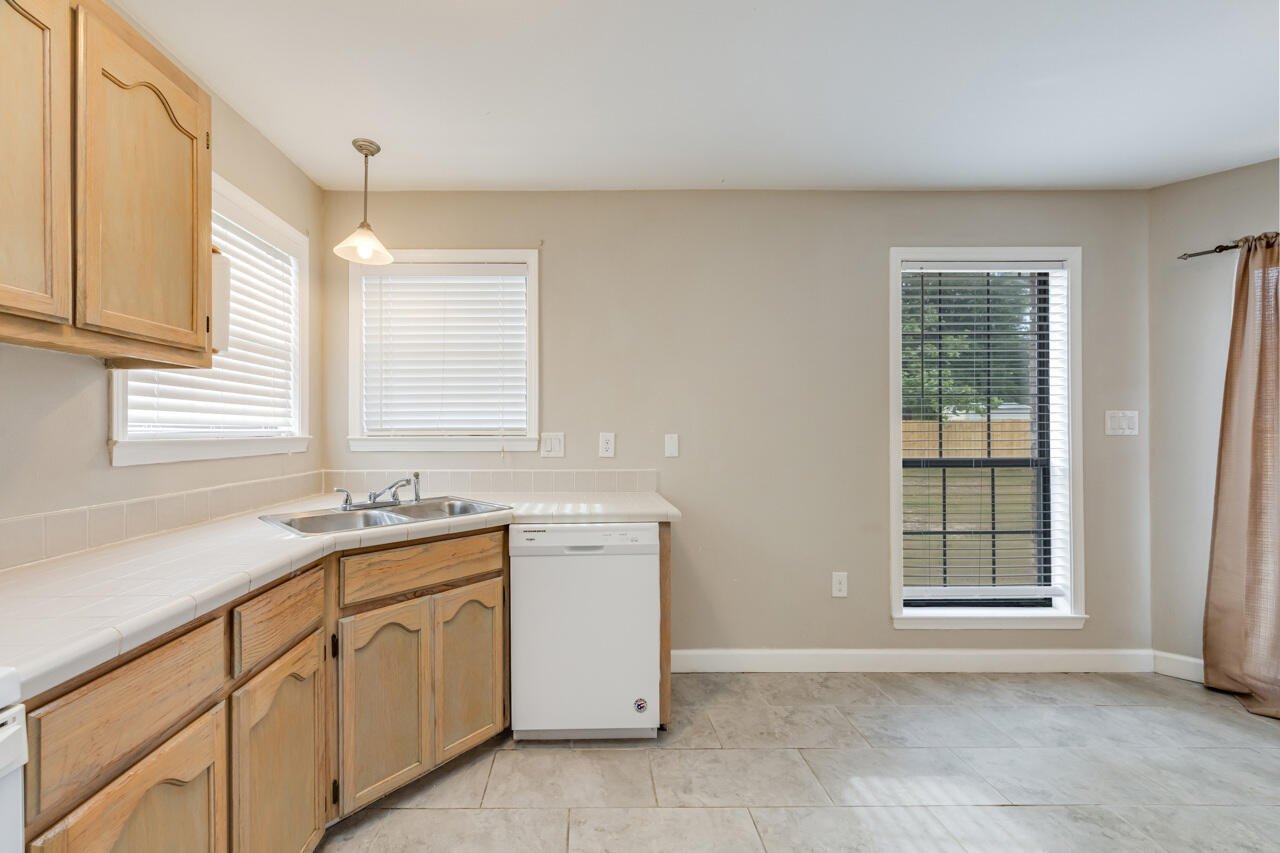 519 Krest Drive Crestview, FL 32536 - Photo 14 of 37 a kitchen with sink cabinets and window