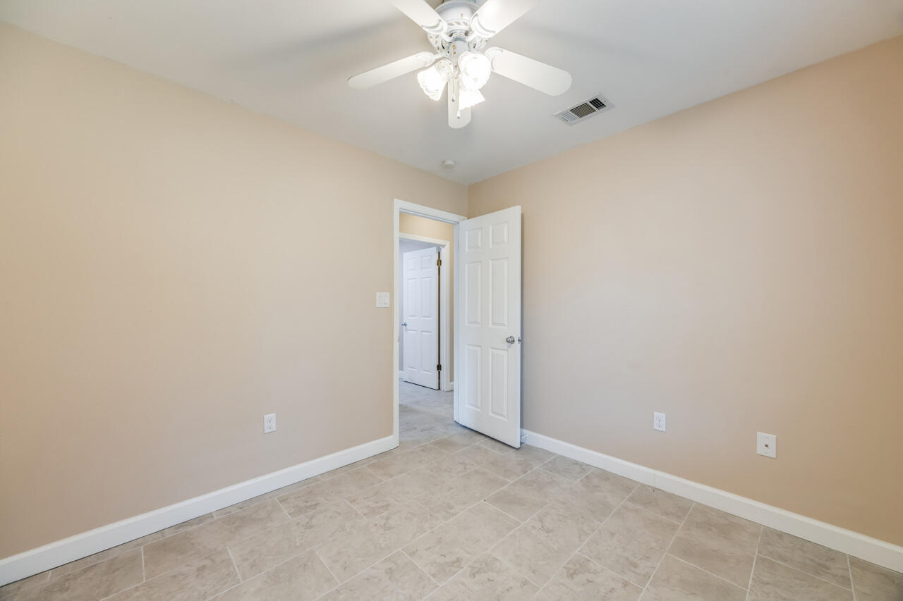 519 Krest Drive Crestview, FL 32536 - Photo 25 of 37 an empty room with a chandelier fan and a chandelier fan