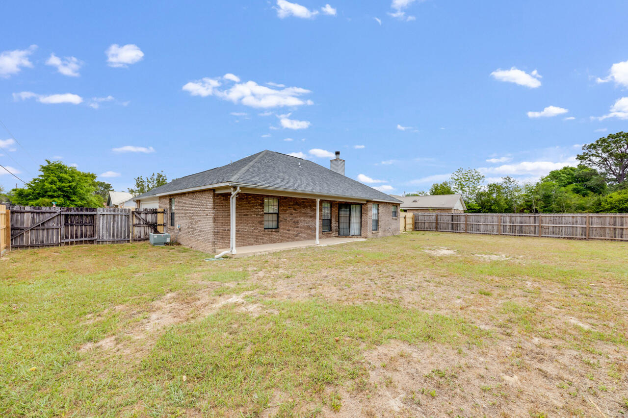 519 Krest Drive Crestview, FL 32536 - Photo 29 of 37 a front view of a house with a swimming pool