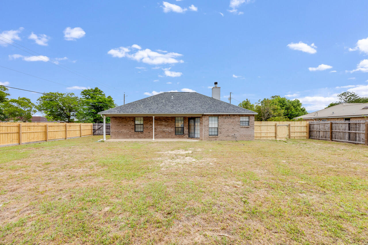 519 Krest Drive Crestview, FL 32536 - Photo 30 of 37 a front view of a house with a yard and garage