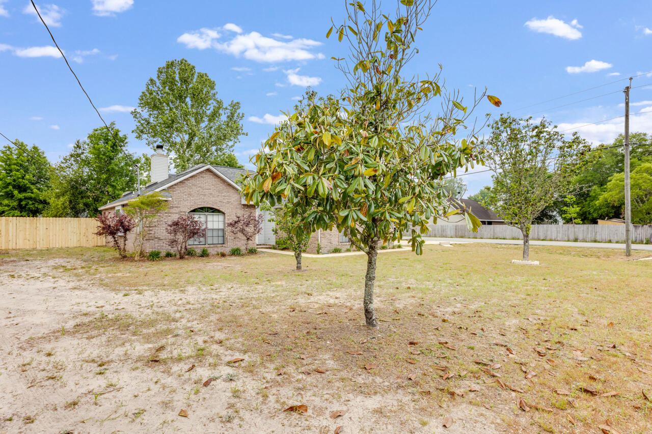 519 Krest Drive Crestview, FL 32536 - Photo 3 of 37 a swimming pool with wooden fence