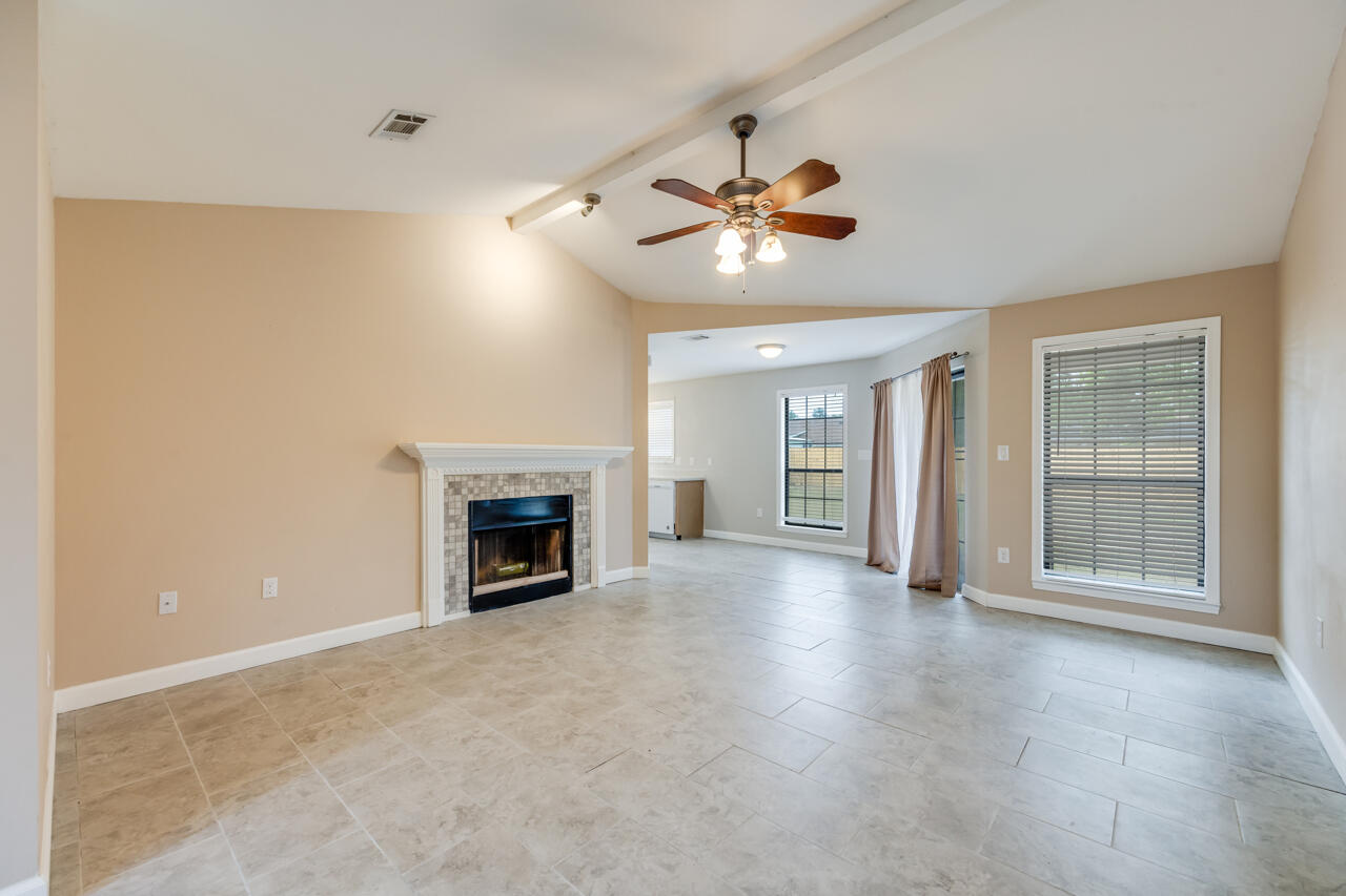 519 Krest Drive Crestview, FL 32536 - Photo 6 of 37 a view of an empty room with a fireplace and a window