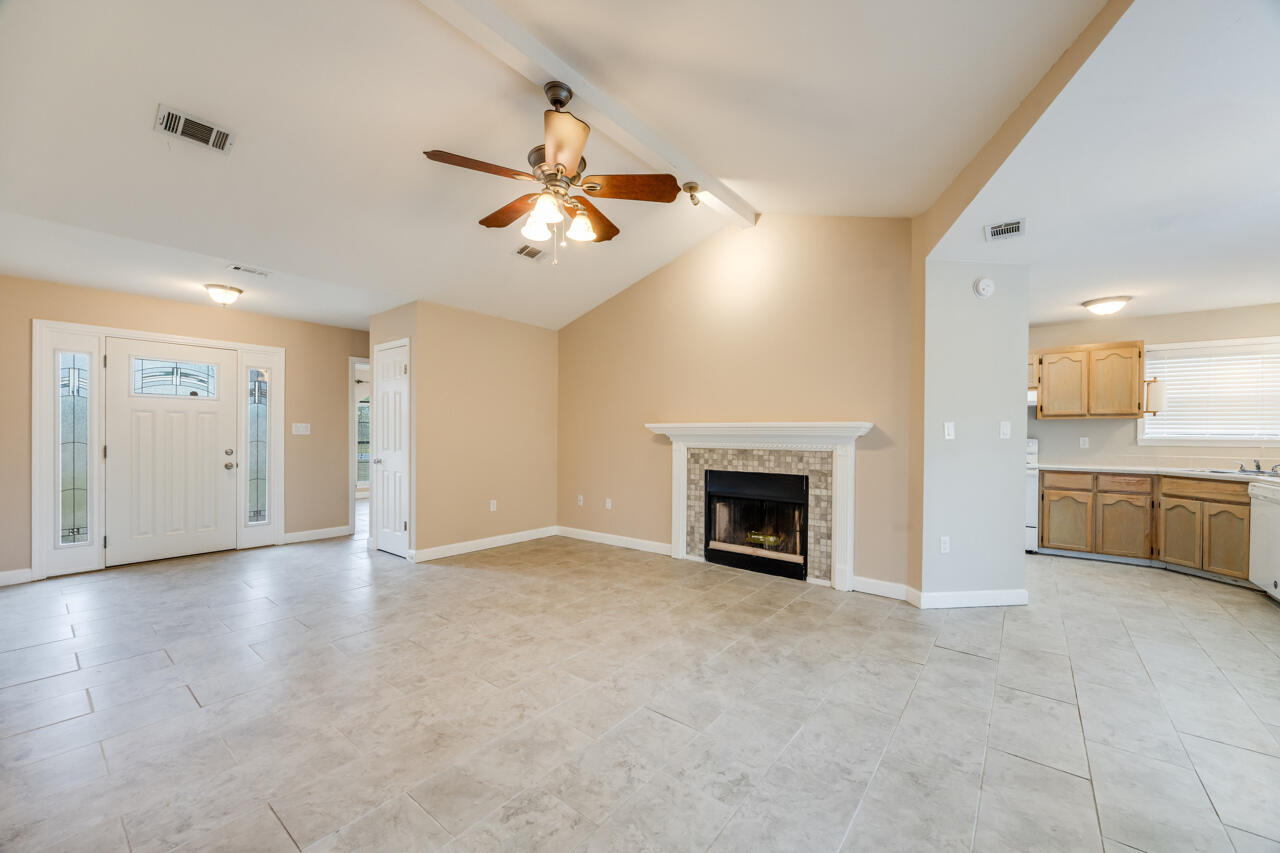 519 Krest Drive Crestview, FL 32536 - Photo 8 of 37 an empty room with a kitchen and a fireplace