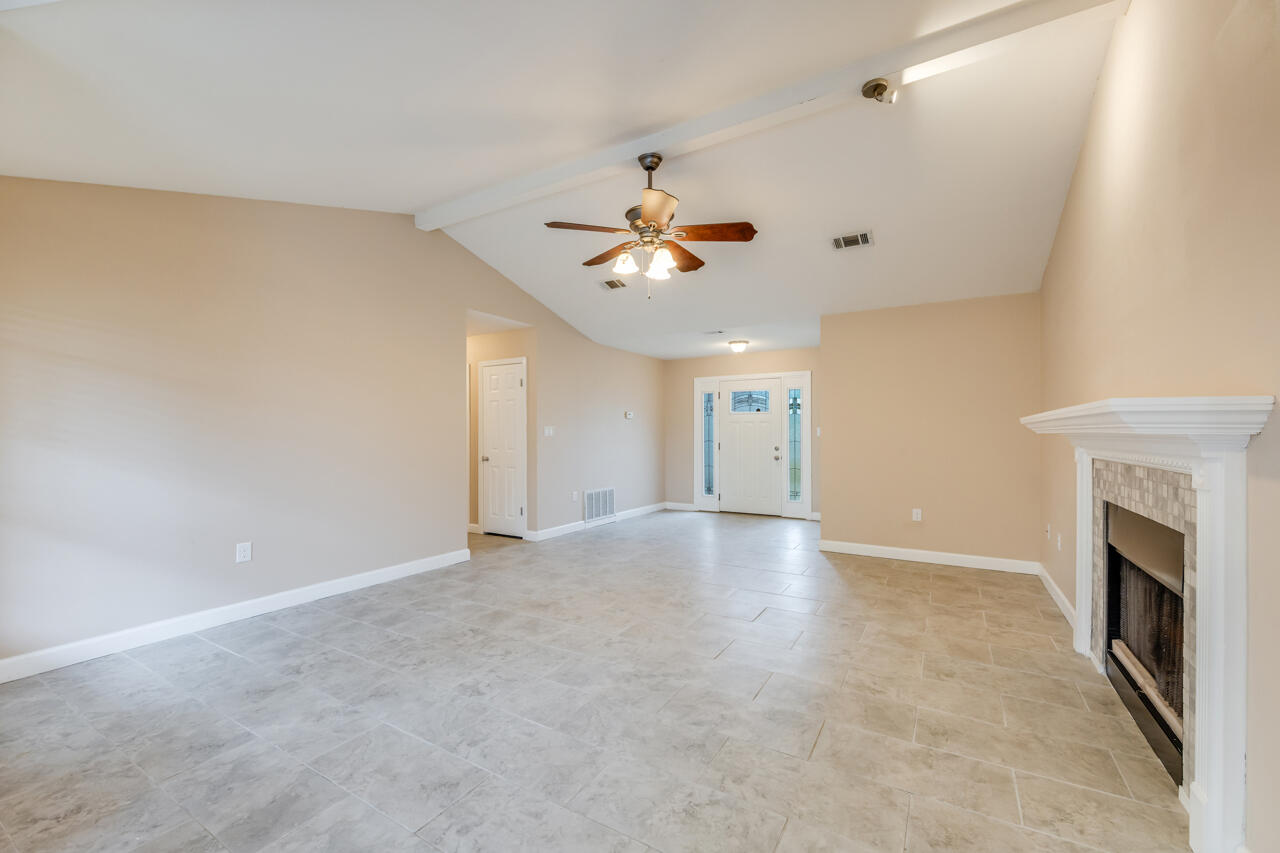 519 Krest Drive Crestview, FL 32536 - Photo 9 of 37 wooden floor in an empty room with a chandelier fan