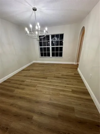 a kitchen with granite countertop a stove a sink and a microwave