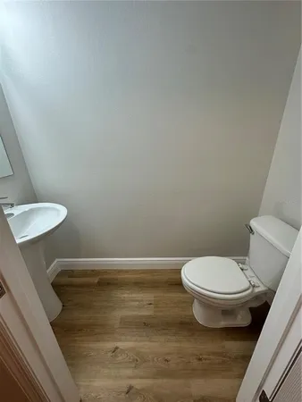a bathroom with a sink a toilet and mirror