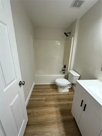 a bathroom with a shower and a toilet