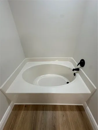 a view of an empty room and wooden floor