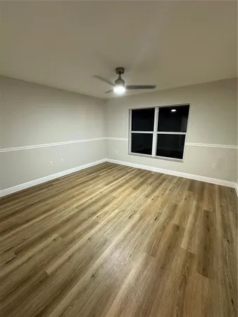 a view of an empty room with a ceiling fan
