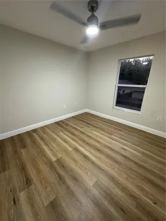 front view of house with a yard and a car parked