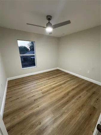 a view of a house with a yard and potted plants