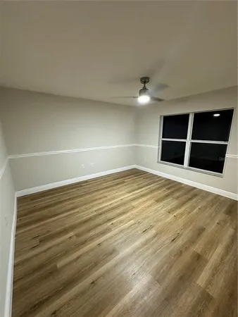 a large kitchen with stainless steel appliances a large counter top a sink a stove and a refrigerator