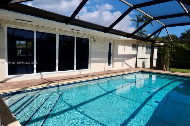 a view of a patio with table and chairs and wooden floor