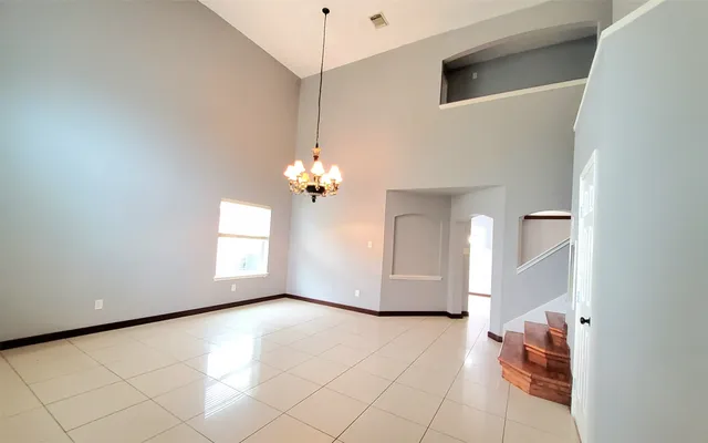 a view of a hallway with entryway wooden floor and stairs