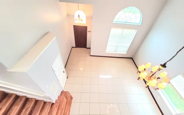 a view of a dining room with furniture and a chandelier