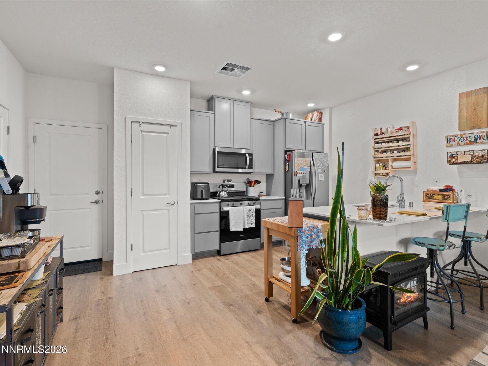 4233 Fawnridge Place Reno, NV 89523 - Photo 12 of 30 a kitchen with stainless steel appliances kitchen island granite countertop a refrigerator and a stove top oven