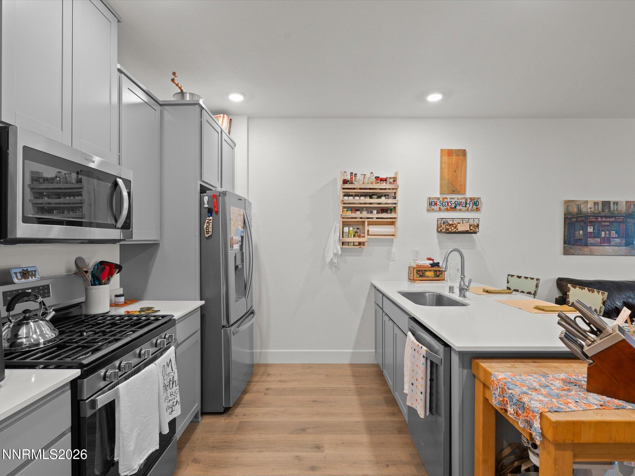 4233 Fawnridge Place Reno, NV 89523 - Photo 8 of 30 a kitchen with stainless steel appliances a sink stove and refrigerator