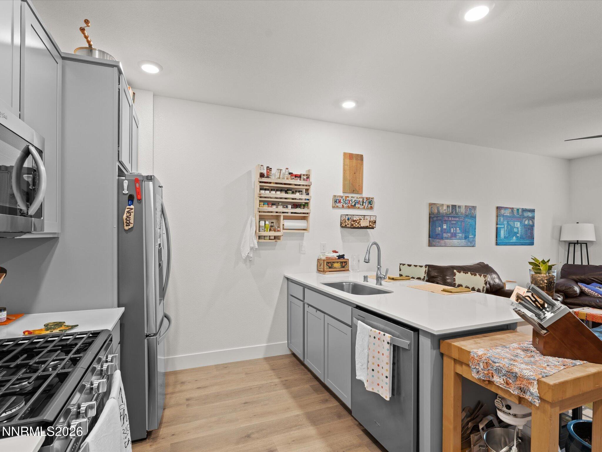 4233 Fawnridge Place Reno, NV 89523 - Photo 9 of 30 a kitchen that has a lot of cabinets a sink and a stove in it