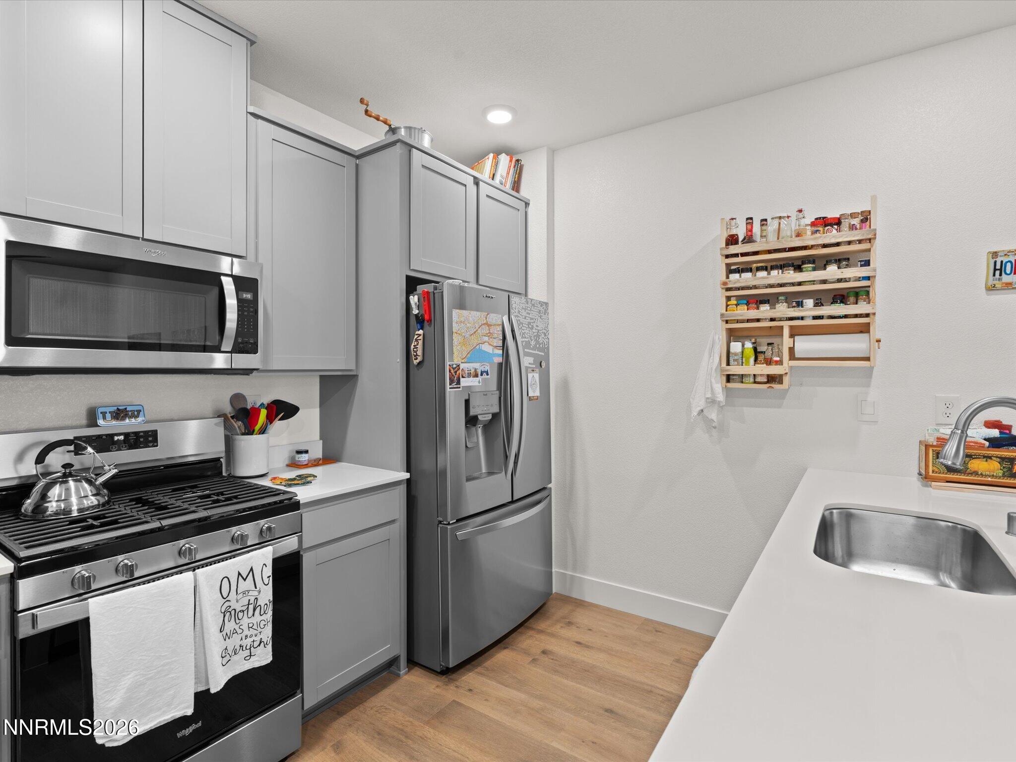 4233 Fawnridge Place Reno, NV 89523 - Photo 10 of 30 a kitchen with stainless steel appliances a stove a sink and a refrigerator