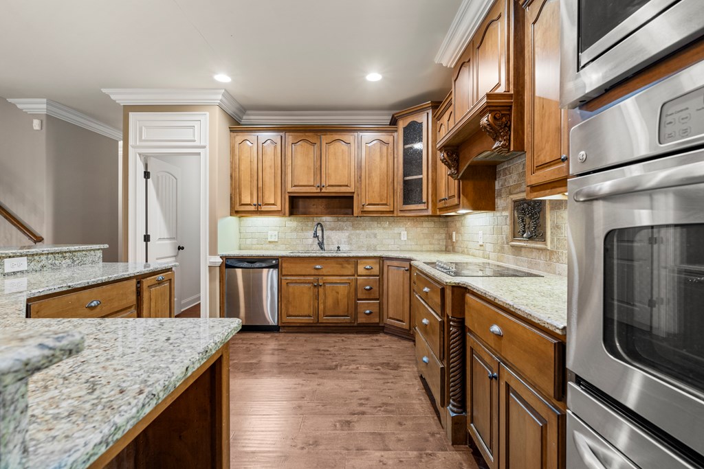 8026 Splendor Way Columbus, GA 31904 - Photo 11 of 44 a kitchen with stainless steel appliances granite countertop a sink stove and refrigerator