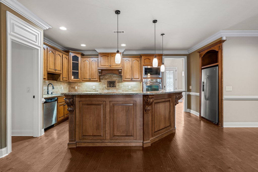 8026 Splendor Way Columbus, GA 31904 - Photo 13 of 44 a kitchen with stainless steel appliances granite countertop a refrigerator a sink a stove and a wooden floors