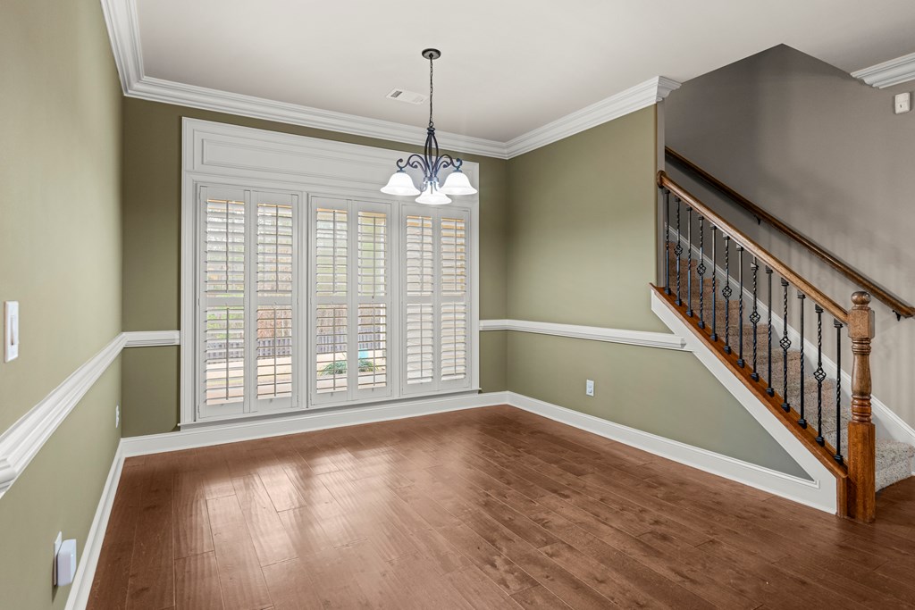 8026 Splendor Way Columbus, GA 31904 - Photo 15 of 44 a view of an empty room with wooden floor and a window