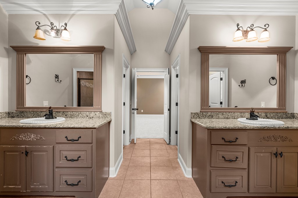 8026 Splendor Way Columbus, GA 31904 - Photo 19 of 44 a spacious bathroom with a granite countertop sink a mirror and a