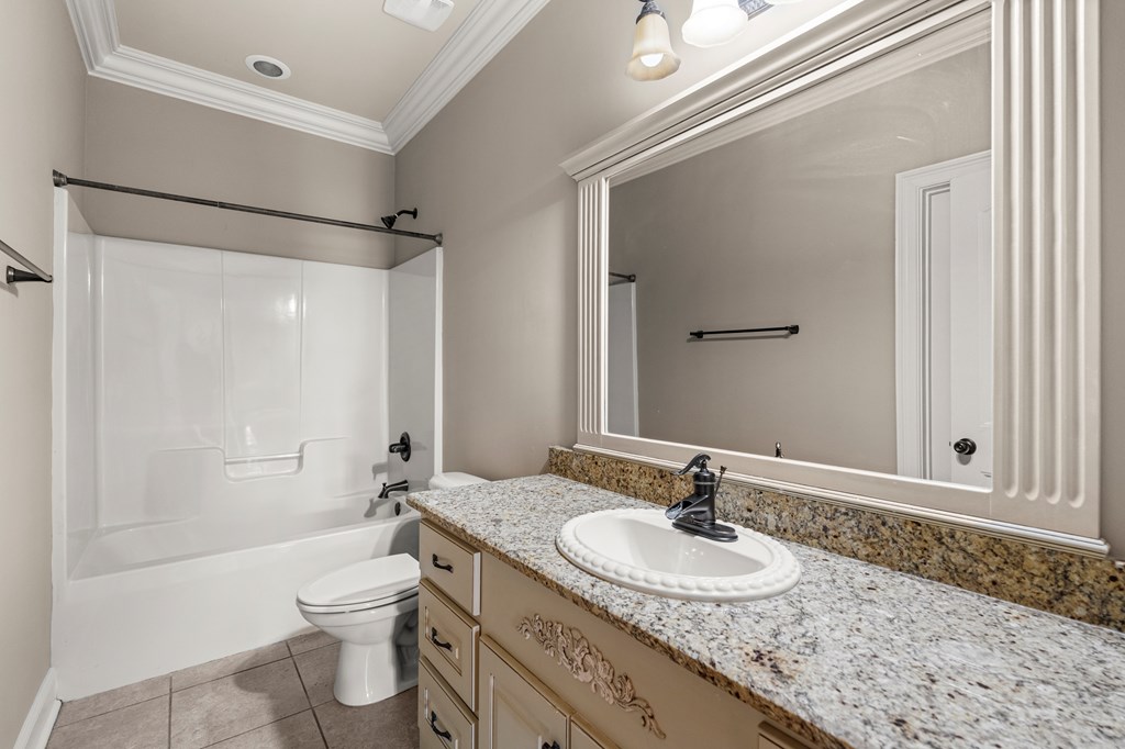 8026 Splendor Way Columbus, GA 31904 - Photo 22 of 44 a bathroom with a granite countertop sink toilet and shower